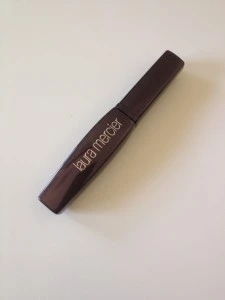 It comes in a nice sparkly maroon-brown tube.